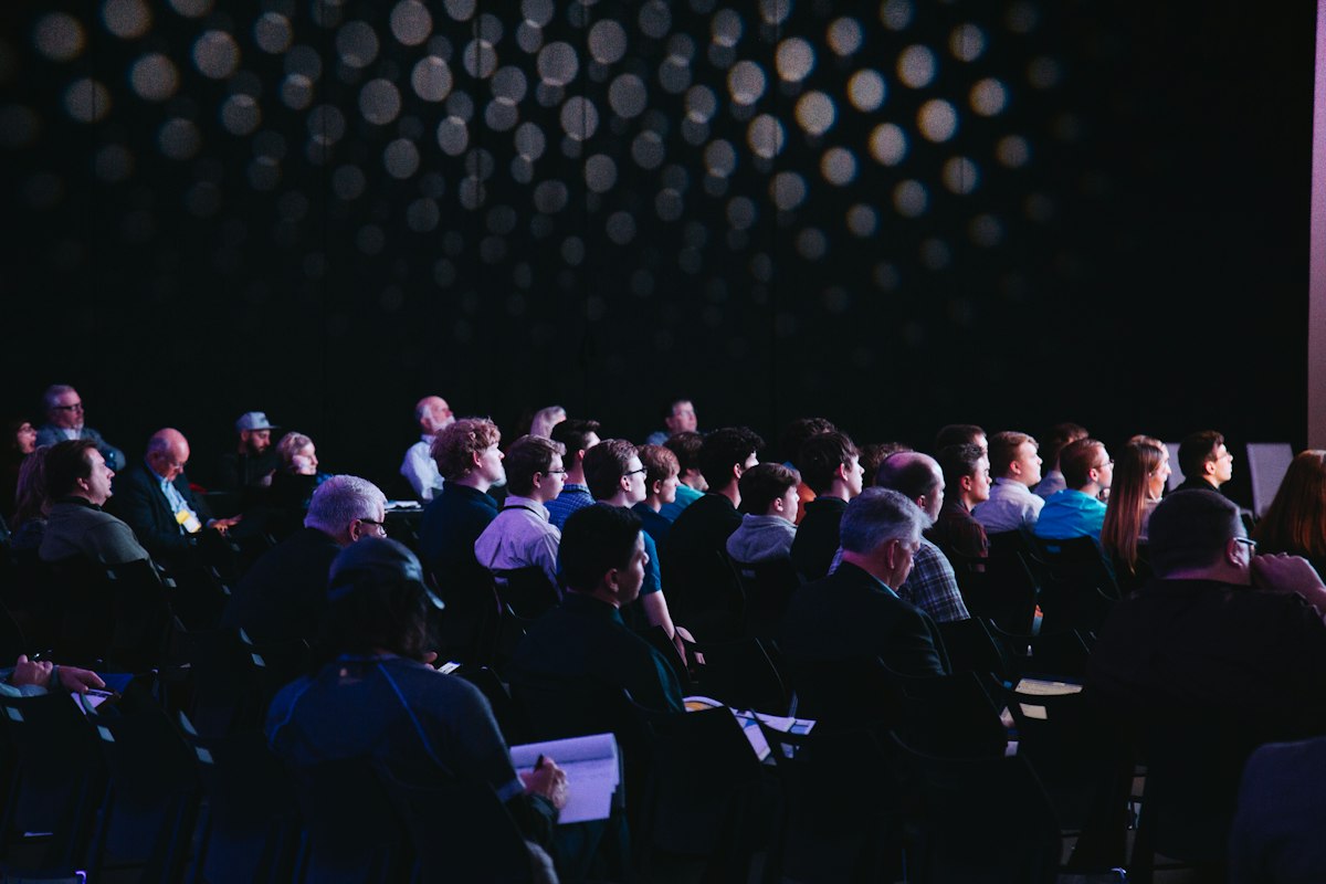 Audience and speakers at a professional conference